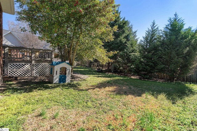 view of yard with a wooden deck and fence