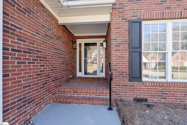 entrance to property with brick siding and crawl space