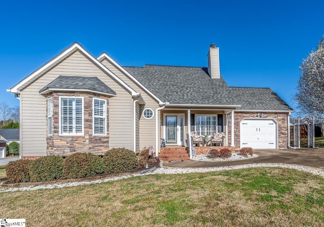 view of front of house featuring an attached garage, a chimney, concrete driveway, a front lawn, and stone siding