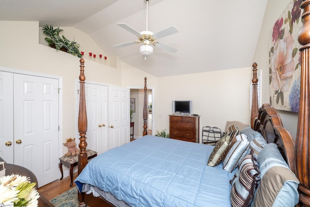 bedroom with a ceiling fan, lofted ceiling, and wood finished floors