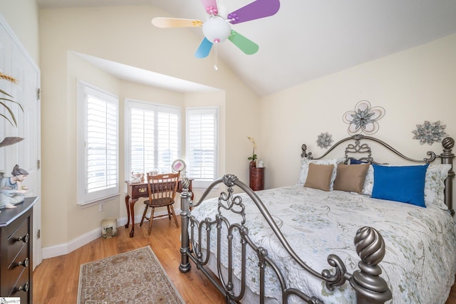 bedroom with ceiling fan, baseboards, light wood-style floors, and lofted ceiling