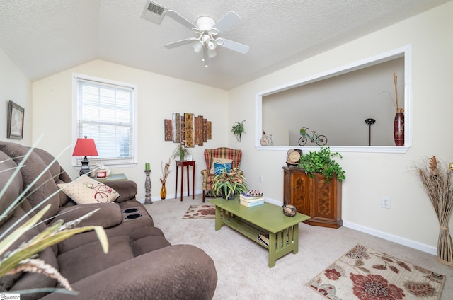 living area featuring carpet, baseboards, visible vents, vaulted ceiling, and a textured ceiling