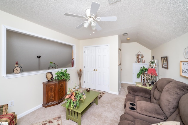 carpeted living area with visible vents, baseboards, vaulted ceiling, a textured ceiling, and a ceiling fan