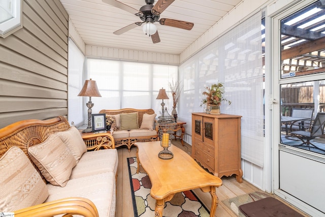 sunroom featuring plenty of natural light and a ceiling fan