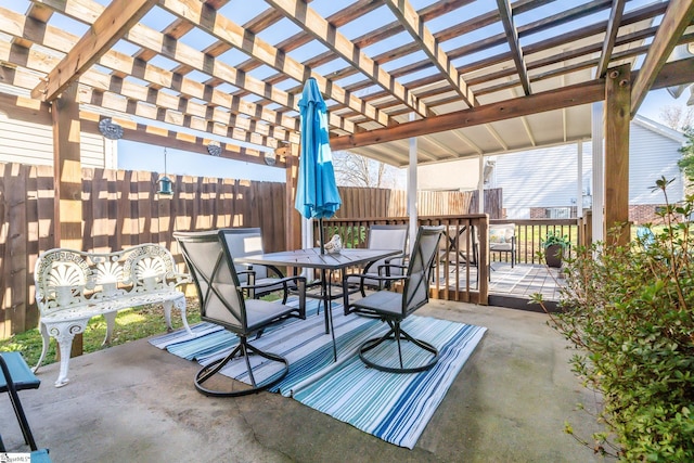 view of patio featuring outdoor dining area, a pergola, and fence