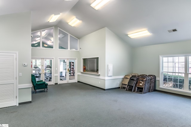 living area featuring visible vents, plenty of natural light, french doors, and high vaulted ceiling