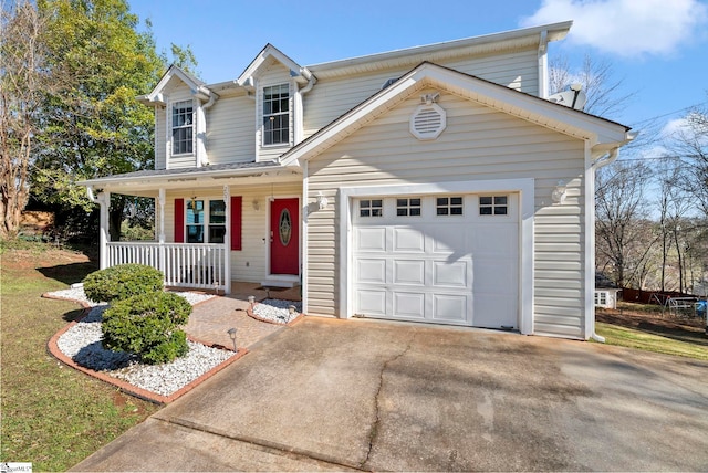 traditional-style house with a porch, an attached garage, and driveway