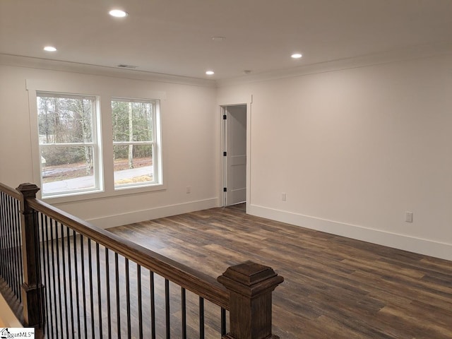 unfurnished room featuring recessed lighting, dark wood-style flooring, and ornamental molding