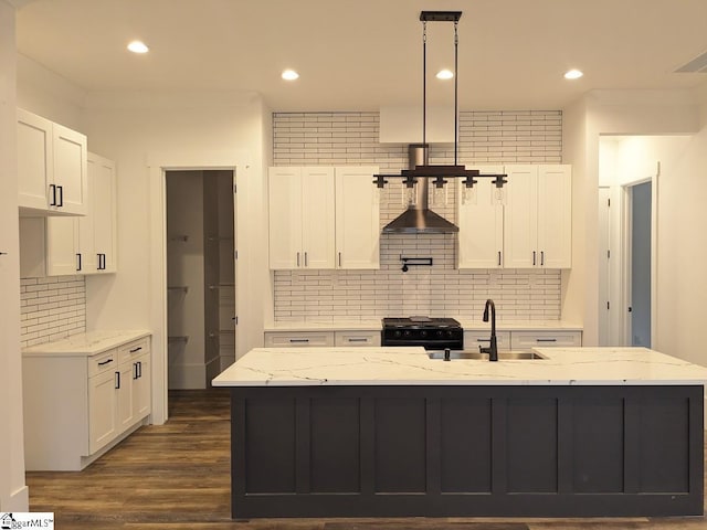 kitchen with a sink, black gas range oven, dark wood-style flooring, and white cabinetry