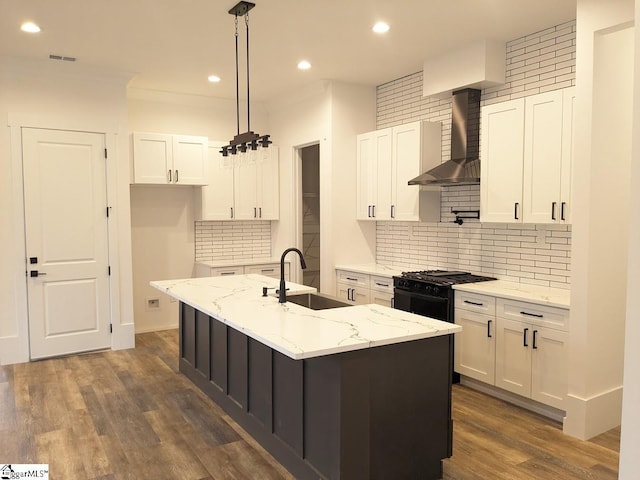 kitchen featuring gas stove, visible vents, dark wood finished floors, white cabinetry, and wall chimney exhaust hood