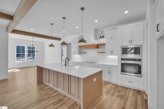 kitchen featuring beam ceiling, open shelves, stainless steel appliances, light countertops, and backsplash