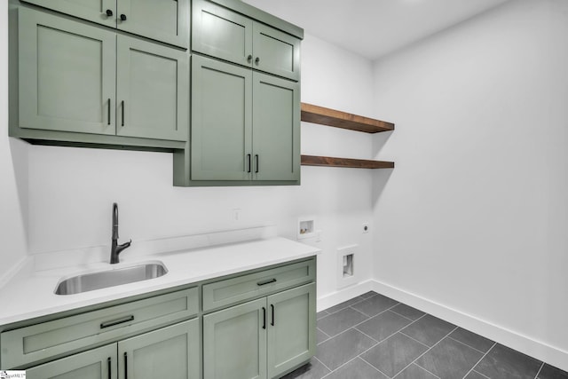 laundry area with baseboards, hookup for a washing machine, cabinet space, hookup for an electric dryer, and a sink