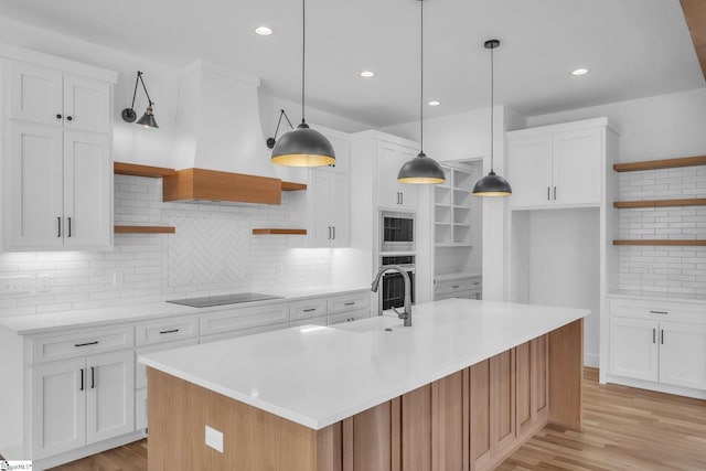 kitchen featuring stainless steel appliances, light countertops, and open shelves