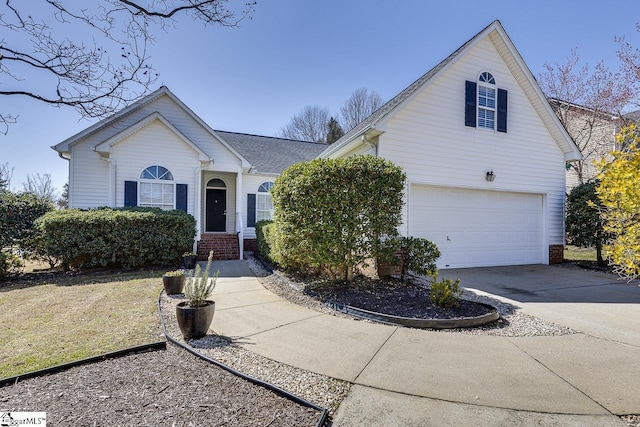 view of front facade featuring brick siding, a garage, and driveway