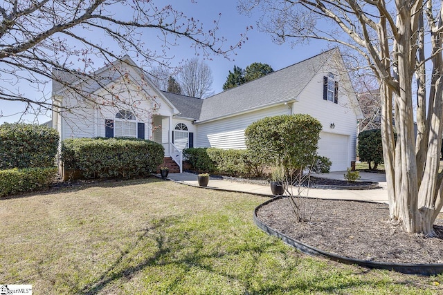 view of front facade with a front yard and an attached garage