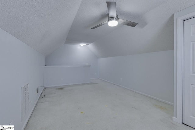 bonus room with visible vents, carpet floors, lofted ceiling, ceiling fan, and a textured ceiling