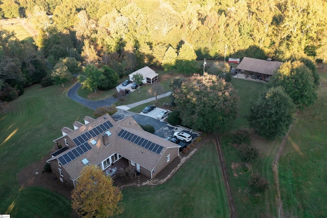 drone / aerial view featuring a wooded view