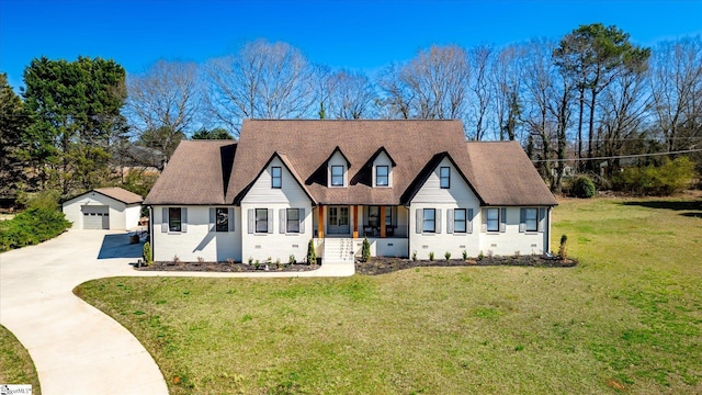 view of front of house with a detached garage, a front lawn, an outdoor structure, crawl space, and driveway