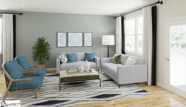 living room with baseboards and wood finished floors