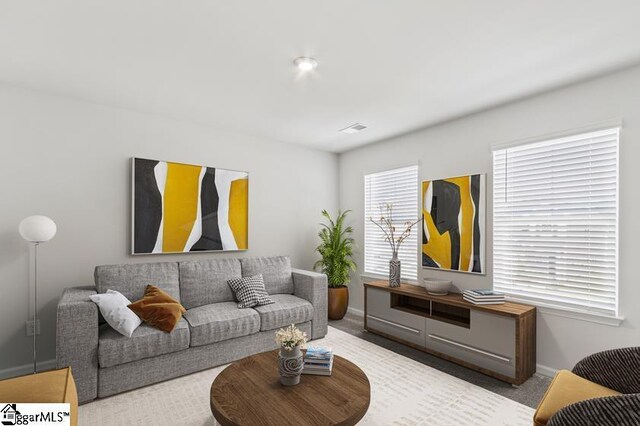 living area with baseboards and carpet floors