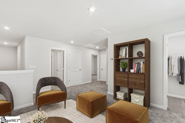 living area with light carpet, recessed lighting, and baseboards