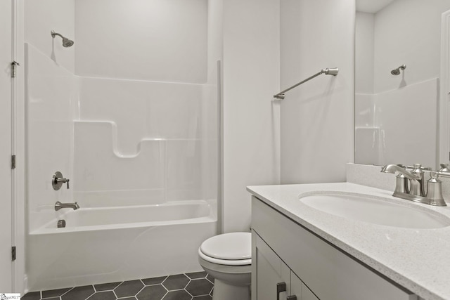 bathroom featuring tile patterned floors, toilet,  shower combination, and vanity