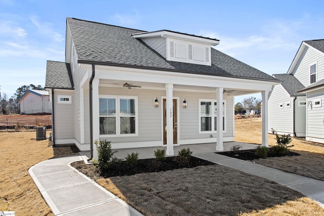 bungalow featuring a porch, central air condition unit, roof with shingles, and ceiling fan