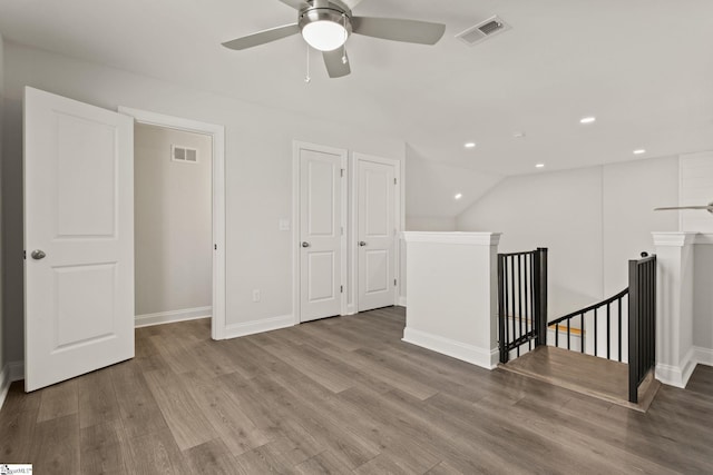 empty room featuring visible vents, recessed lighting, baseboards, and wood finished floors