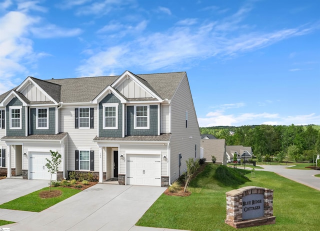 view of front of property with a garage, stone siding, board and batten siding, and driveway