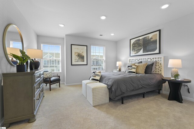 bedroom with recessed lighting, light colored carpet, visible vents, and baseboards