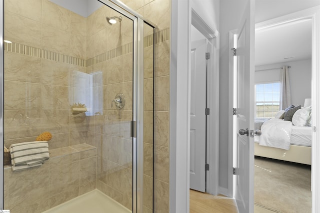 ensuite bathroom with a stall shower and connected bathroom