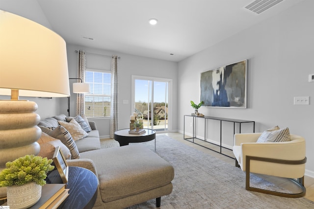 living room featuring baseboards and visible vents