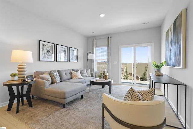 living room featuring recessed lighting, light wood-style floors, visible vents, and baseboards