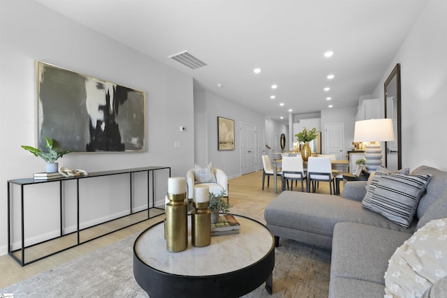 living area with recessed lighting, visible vents, and light wood-style flooring