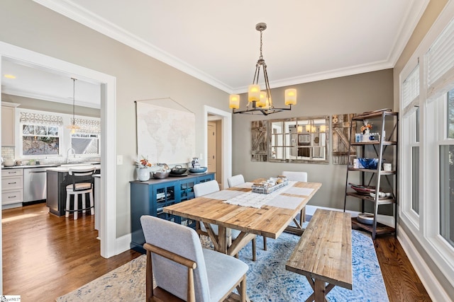 dining space with ornamental molding and dark wood-style flooring