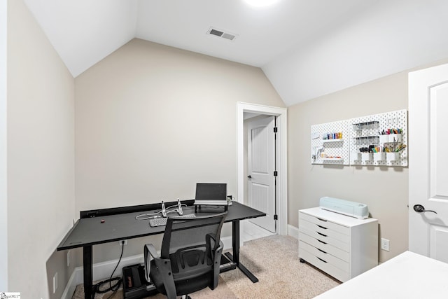 office area with light carpet, visible vents, and vaulted ceiling