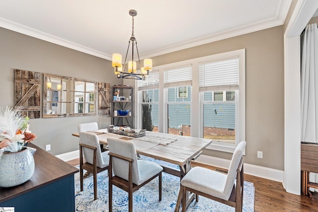 dining room featuring a healthy amount of sunlight, wood finished floors, and crown molding