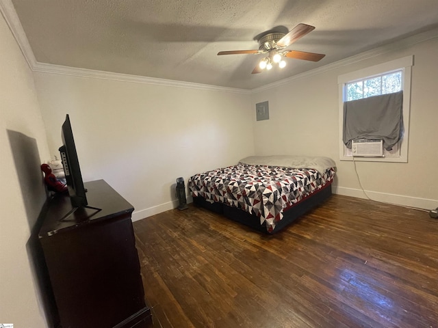 bedroom with ornamental molding, a textured ceiling, baseboards, and wood finished floors