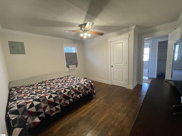 bedroom with ornamental molding, electric panel, a textured ceiling, dark wood finished floors, and baseboards