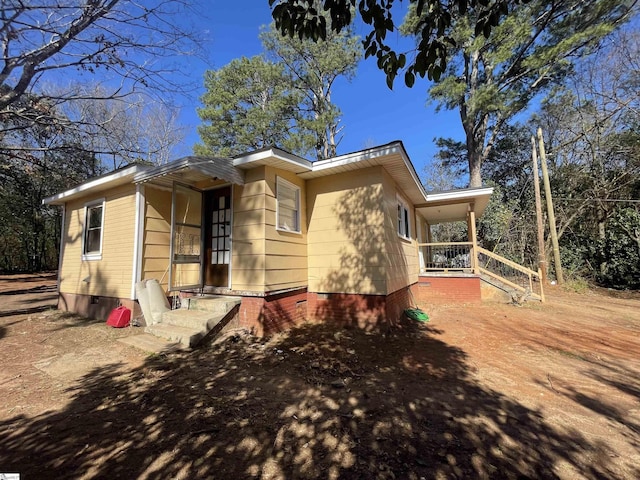 view of side of home with crawl space