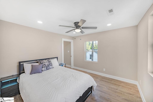 bedroom featuring wood finished floors, recessed lighting, baseboards, and visible vents