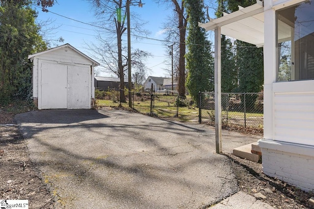 exterior space with a storage shed and fence