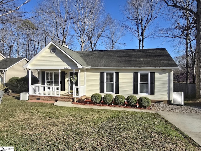 ranch-style house featuring a porch, a front yard, and fence