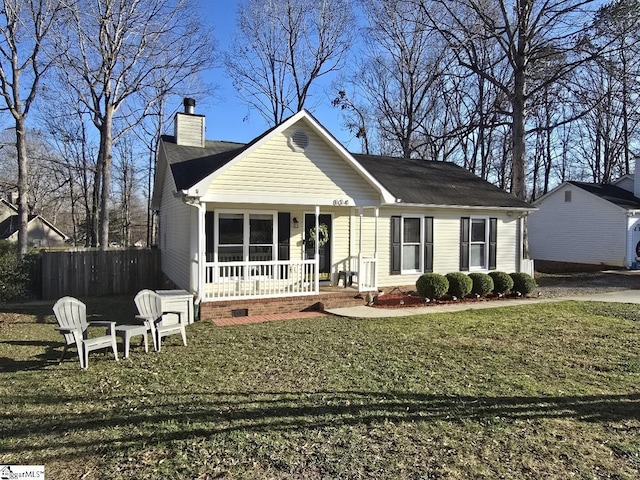 view of front of home with fence, a front yard, covered porch, a chimney, and crawl space