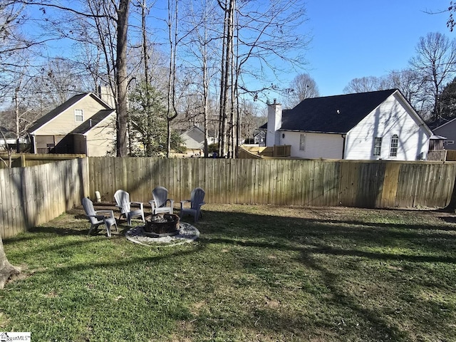 view of yard featuring a fire pit and fence