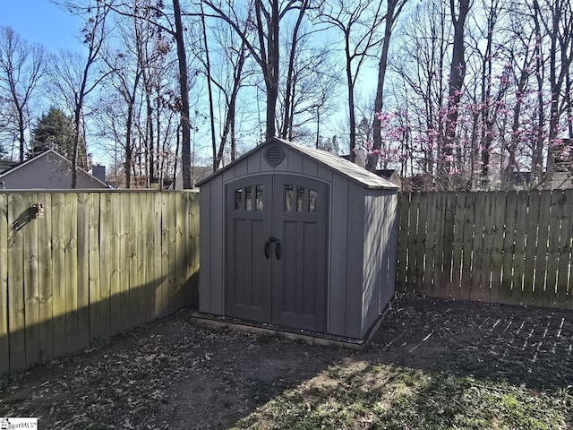 view of shed with a fenced backyard