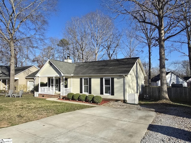 single story home featuring fence, covered porch, a front yard, crawl space, and a chimney