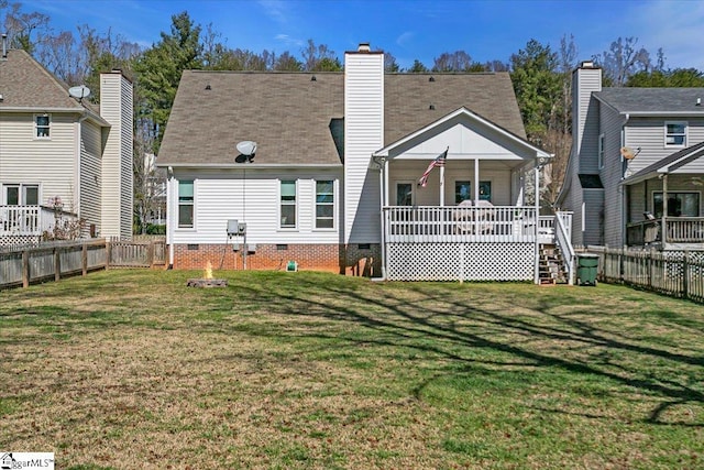 rear view of property with crawl space, a yard, covered porch, and a fenced backyard