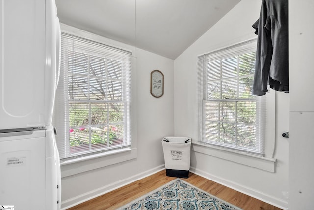 sitting room with baseboards, a healthy amount of sunlight, wood finished floors, and vaulted ceiling