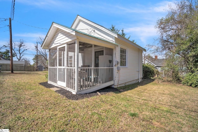 exterior space featuring fence and a sunroom